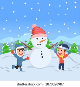 two kids playing under the falling snow and making snowman