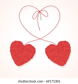 Two knotted balls of threads in form of heart