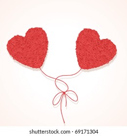 Two knotted balls of threads in form of heart