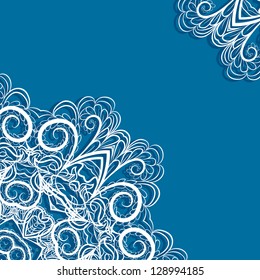 Two lace corners with abstract floral pattern on blue background looks like crocheting handmade lace.