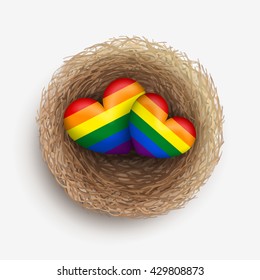 Two LGBT-colored hearts are laying together in nest. Homosexual couple concept