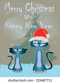 Two little cats on Christmas snow with Christmas tree