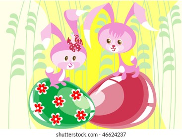 Two little pink Easter bunny sitting on the colored eggs