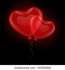 Two lovers soaring red gel balloons in the shape of hearts of interlaced ribbons on a black background.