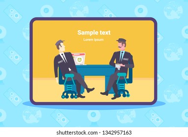 two male security guard workers discussing men in uniform sitting at workplace desk with laptop screen copy space full length flat horizontal