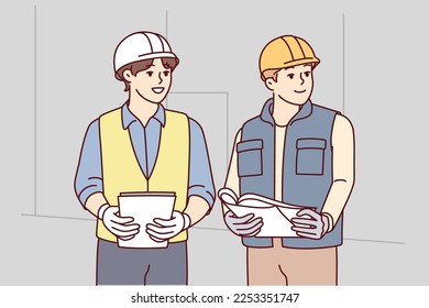 Two man builders in worker uniform look to side discussing construction process. Architects or engineers wearing protective helmets stand with papers in their hands at workplace. Flat vector image