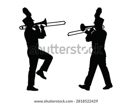 Two marching band musicians playing trombones in silhouette