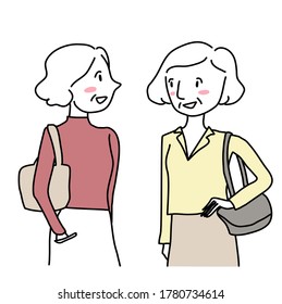 Two mature women talking casually. Happy senior women talking while walking together. Half-length portrait of two mature businesswomen walking and talking. Cheerful women with handbags talking.
