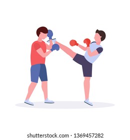 two men boxers exercising thai boxing in red gloves couple fighters practicing at the fight club healthy lifestyle concept flat white background