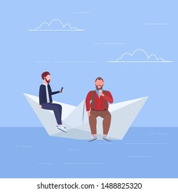 two men floating on paper boat guys using gadgets traveling together digital addiction web surfing concept full length flat
