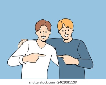 Two men friends hug and point finger towards buddy, rejoicing at long-awaited meeting. Boys brothers or friends smile looking at screen and experience positive emotions from opportunity to communicate