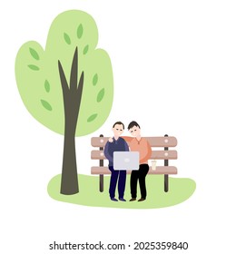 Two  men with a laptop on a park bench. Workplace in nature.