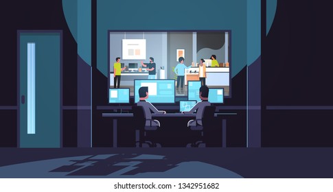 two men looking at monitors behind glass consultants provides expert advice to customers in modern technology store dark office interior surveillance security system flat horizontal