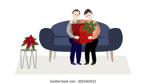 Two men are sitting on the couch looking at a Christmas present in a red box.