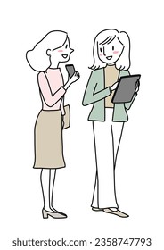 Two office ladies talking and showing phone to each other. Friendly young woman interact with her coworker. Happy businesswoman looking at mobile phone screen which her colleague showing.