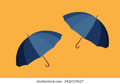 Two open umbrellas isolated on orange background