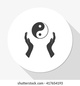 Two opened hands holding Yin Yang symbol.