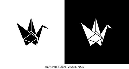 Dos grúas de origami, una negra sobre blanca y otra blanca sobre negra, crean una imagen llamativa.