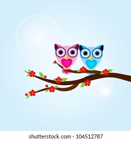 Two owls on the tree