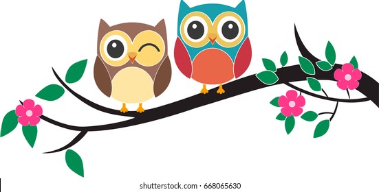 Two owls on the tree in the spring time