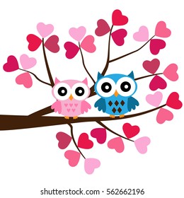Two Owls sitting on the branch in  the hearts
