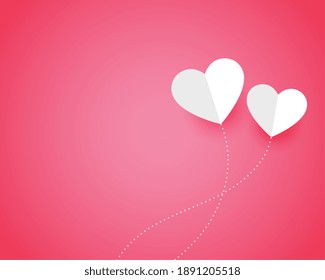 two paper hearts on pink background with text space