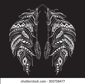 Two patterned feathers in the ornaments on a black background