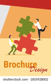 Two people connecting puzzle parts. Colleagues or partners working on solution together flat vector illustration. Teamwork, challenge concept for banner, website design or landing web page