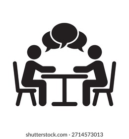 Two people seated at a table engaged in a conversation with speech bubbles