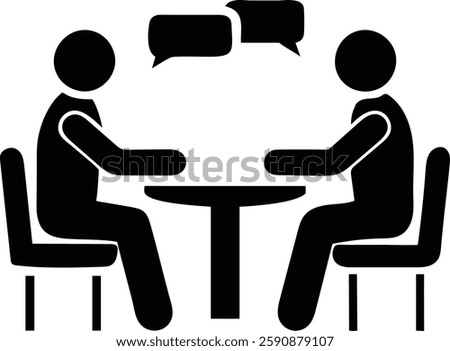 Two people seated at a table, engaged in a conversation