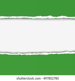 Two pieces of torn green color paper with ripped edges and white hole between them