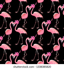 Two pink flamingos on a black background. Seamless pattern. Vector.
