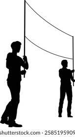 Two protestors or demonstrators at a demonstration march, picket line or strike protest rally in silhouette. Holding up a banner sign.