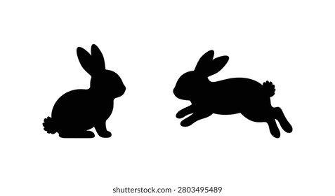 Two rabbit silhouettes one sitting and one leaping against a white background silhouette bunny hare lepus rabbit shape animal figure