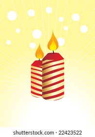 two red burning candles on yellow dotted background