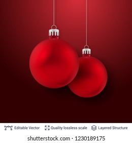 Two red Christmas balls on dark background. 3D glossy fir tree decorative toys. New Year holiday template.