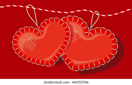 two red hearts made of cloth and red and white rope