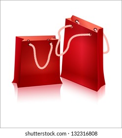 Two red package for shopping with handles - with ropes.