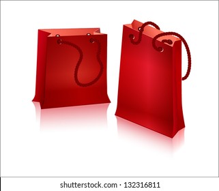 Two red package for shopping with handles - with ropes.