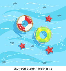 Two Ring Buoys With Blue Sea Water On Background