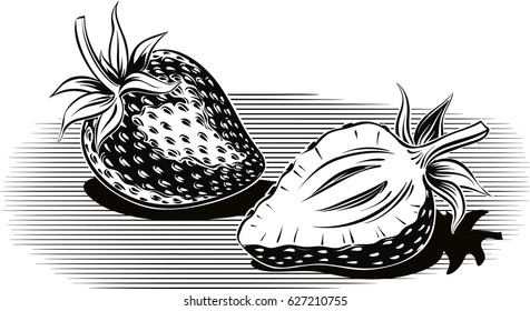 Two ripe strawberries, one cut in half.