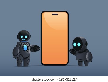 two robots standing near smartphone with blank screen robotic character artificial intelligence technology concept