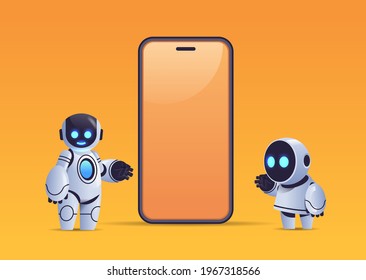 two robots standing near smartphone with blank screen robotic character artificial intelligence technology concept