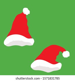 Two Santa hats  on a green background.
