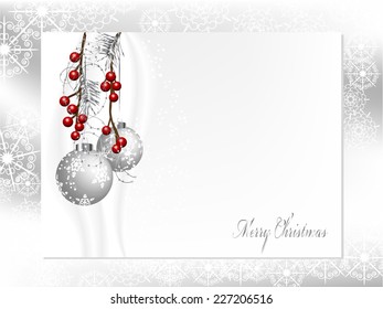 Two silver christmas balls with needles and berries