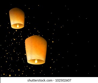 Two sky lantern in the night sky. Eps 10