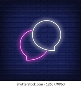Two speech bubbles neon sign. Glowing inscription chat bubble on brick wall background. Vector illustration can be used for topics like internet, web, chatting, communication