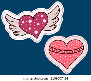 Dos pegatinas de un corazón. Con alas y decoración