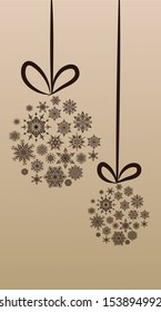 Two stylized Christmas ball from snowflakes on a thread on the beige background