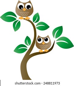 Dos búhos marrones dulces en un árbol